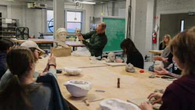 Art professor demonstrating with some clay during class