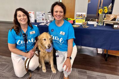 Sue Briggs and Kathy L'Heureux from the Health and Wellness team with a comfort dog. 