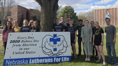 Bulldogs for Life members in front of a Nebraska Lutherans for Life sign on campus. 