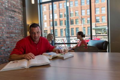 A graduate student studying in a coffee shop.