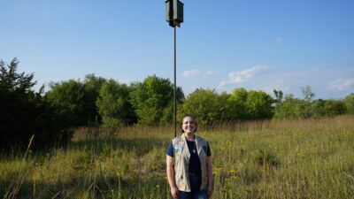 Photo Courtesy of Chrystal Houston, Public Relations Manager of the Upper Big Blue Natural Resources District. Elizabeth Marsh next to one of the bat houses she built.