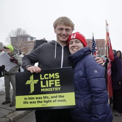 Two students holding up a sign for LCMS Life Ministry