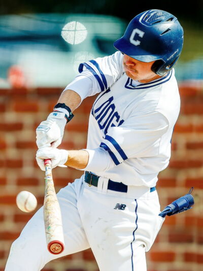 Concordia baseball player swinging at a ball.