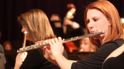 Close up of a Concordia student playing the flute